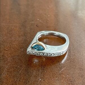 Blue topaz ring in sterling silver and 14k yellow gold with white sapphire.